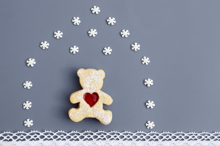 Creative romantic concept - linzer cookie in a shape of bear with heart in a house created from...