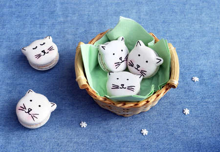 Cute macarons in a shape of cats, small sugar snowflakes around. Christmas or winter time. Creative bakingの写真素材