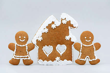 Romantic gingerbread house and smiling couple, Christmas time