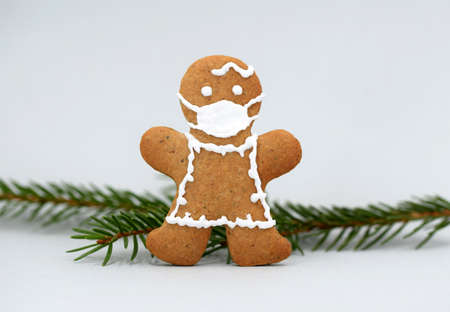 Gingerbread woman with protective face mask and spruce twig, copy spaceの写真素材