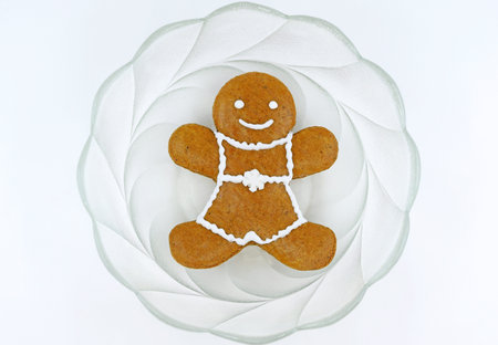 Gingerbread man in a glass bowl, top view, white backgroundの写真素材