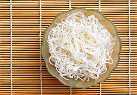 <p>Cooked rice noodles in a bowl, top view</p>