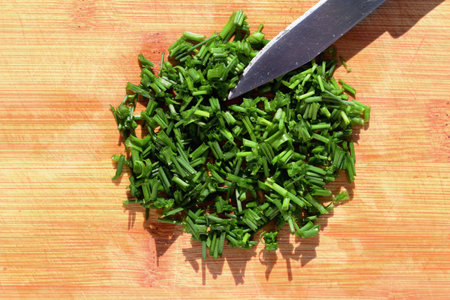 Fresh chopped chives on cutting board