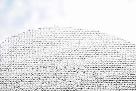 Thin patterned slab of ice against the sky. Abstract background
