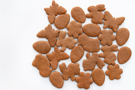 Undecorated Easter gingerbread cookies of various shapes on a white background