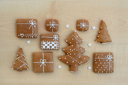 Decorated gingerbread cookies - trees and christmas presents with small sugar snowflakesの写真素材