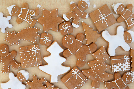 Decorated Christmas gingerbread cookies of various shapes, with small sugar snowflakesの写真素材