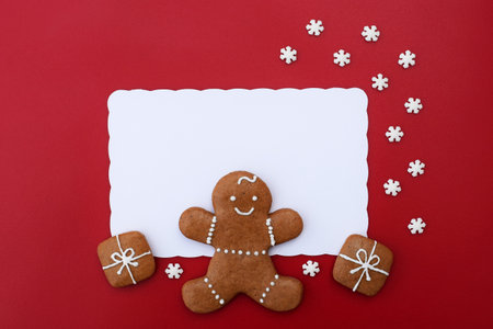 Decorated gingerbread cookies - gingerbread man and christmas presents with small sugar snowflakes, white space for textの写真素材