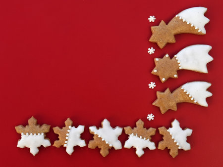 Gingerbread comets and snowflakes on a red background, copy space for textの写真素材