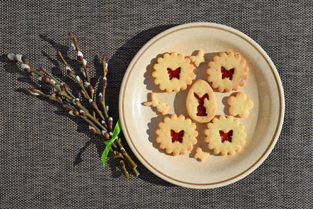 Homemade Linzer cookies with strawberry jam and willow twigs. Easter baking