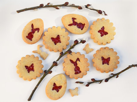 Homemade Linzer cookies with strawberry jam and willow twigs. Easter baking