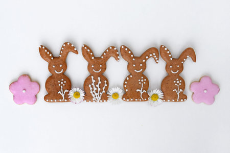 Romantic decorated Easter gingerbread cookies in a shape of bunny and flower, with daisy flowers,...