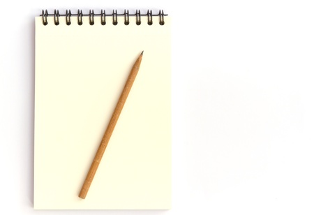 note and pencil on white backgroundの写真素材