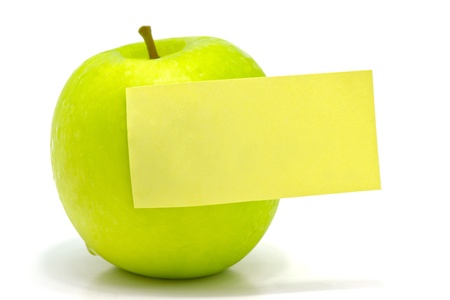 green apple with blank noteの写真素材