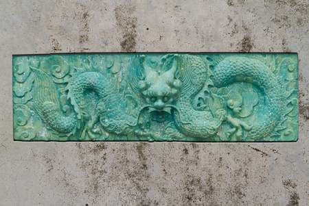 green dragon engraving on old wallの写真素材