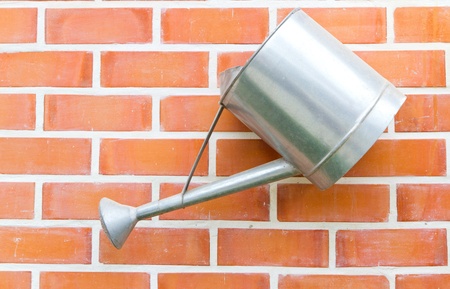 watering can hanging on the wallの写真素材