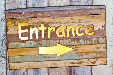 entrance on old plate on wooden boardの写真素材