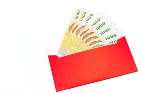 thai money in red envelopeの写真素材