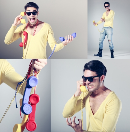 funny call center guy with hipster glasses and colouful phonesの写真素材