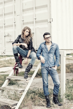 attractive fashionable couple wearing jeans posing dramatic - retro processed imageの写真素材