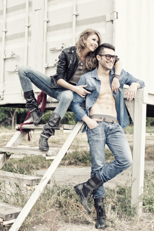stylish couple wearing jeans and boots smiling - retro processed imageの写真素材