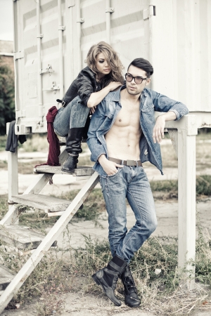 attractive fashionable couple wearing jeans posing dramatic - retro processed imageの写真素材