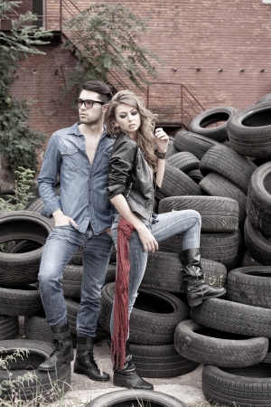 Sexy and fashionable couple wearing jeans, shoot in a grungy location - landscape orientation with copy-spaceの写真素材