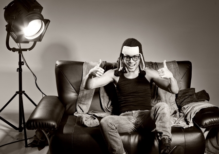 Sexy man doing a fashion photo shoot in a professional studioの写真素材