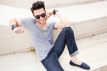attractive man dressed casual posing outdoorsの写真素材