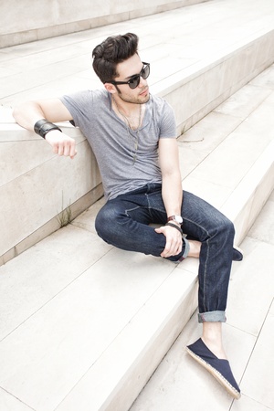 attractive young male fashion model dressed casual - outdoorの写真素材