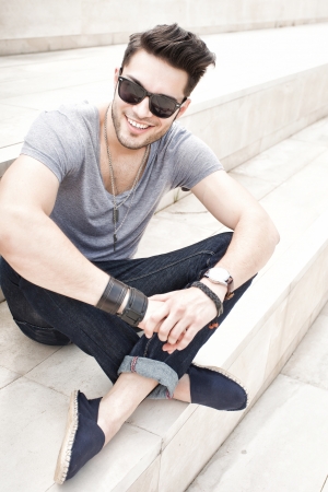 handsome male fashion model smiling, dressed casual - outdoorの写真素材