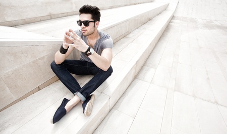 attractive young male model with serious attitude in a minimal spaceの写真素材