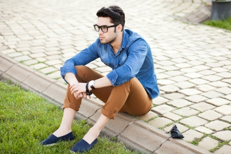 handsome young man posing outdoorsの写真素材