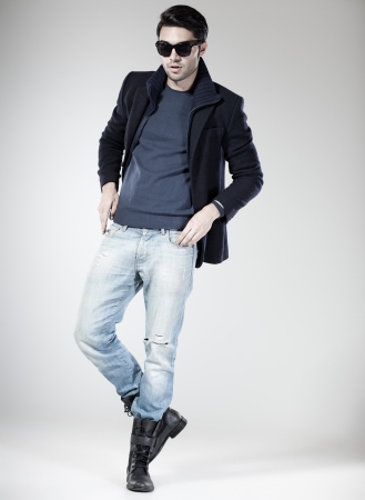 handsome man dressed casual posing in the studioの写真素材