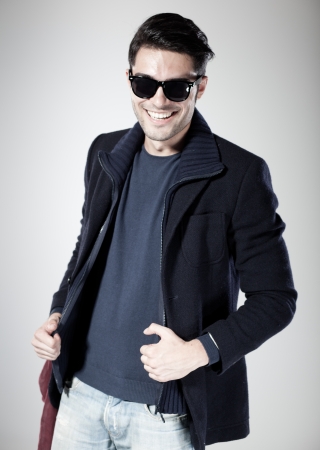 attractive man smiling and posing in the studioの写真素材