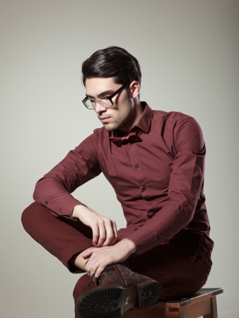 handsome man dressed elegant posing in the studioの写真素材