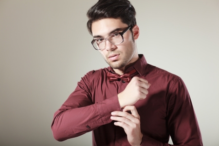handsome male model dressed elegant posing in the studio looking seriousの写真素材