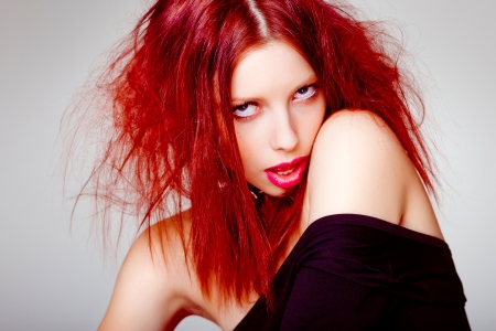 sexy red haired woman, punk attitude posing in the studioの写真素材