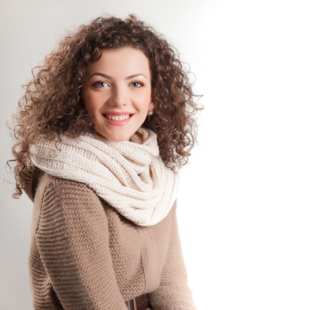beautiful woman dressed in winter clothes smiling - studio shotsの写真素材