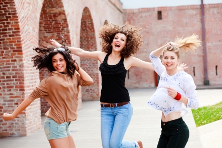 three beautiful women laughing and having funの写真素材