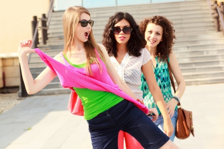 three beautiful women laughing and having funの写真素材