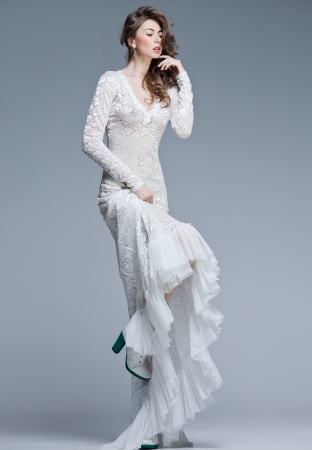 beautiful woman in long white dress posing fashion in the studioの写真素材