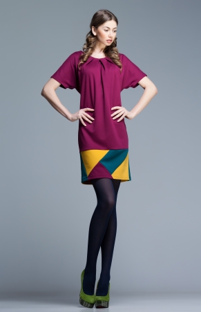 cute woman in colorful summer dress on grey backgroundの写真素材