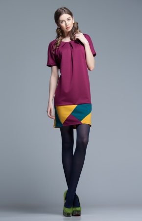 cute woman in colorful summer dress on grey backgroundの写真素材