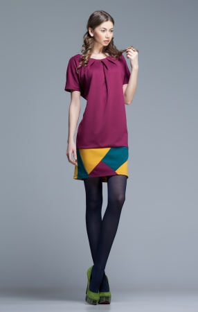 cute woman in colorful summer dress on grey backgroundの写真素材