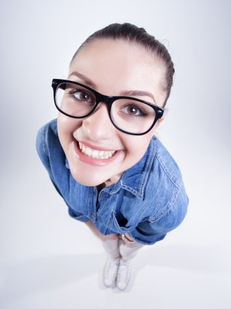 pretty girl wearing geek glasses smiling の写真素材