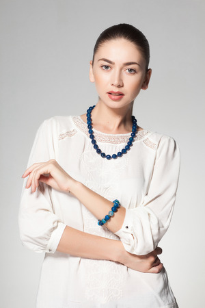 beautiful woman wearing marble necklace on grey backgroundの写真素材
