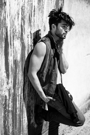 handsome man model dressed punk, hipster posing dramatic in grunge locationの写真素材