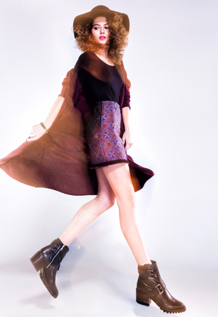 pretty woman with curly hair dresed casual posing in the studio - intentional motion lightの写真素材