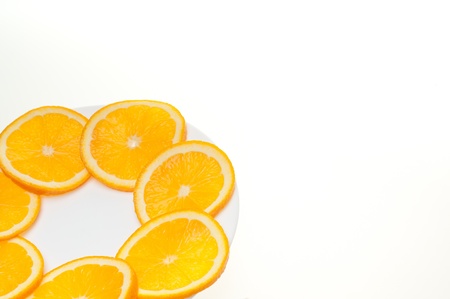 Fresh juicy orange section isolated on white plateの写真素材